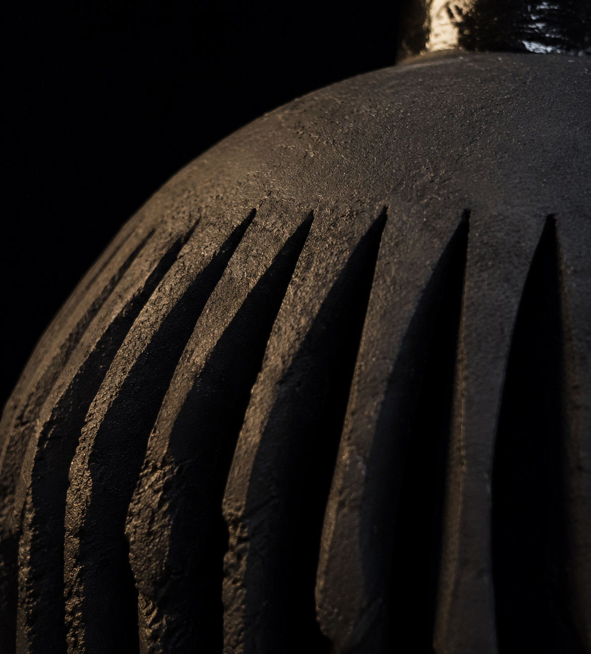 Macro detail of the carved black clay surface